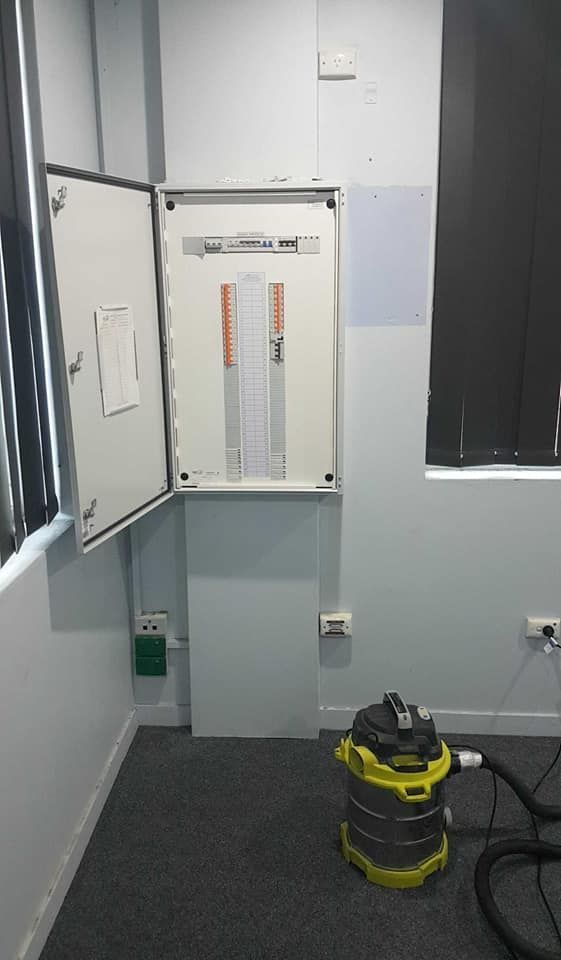 Electrical Panel With Open Door, Next to a Window, and a Vacuum Cleaner — Ionspark Electrical in Mareeba, QLD