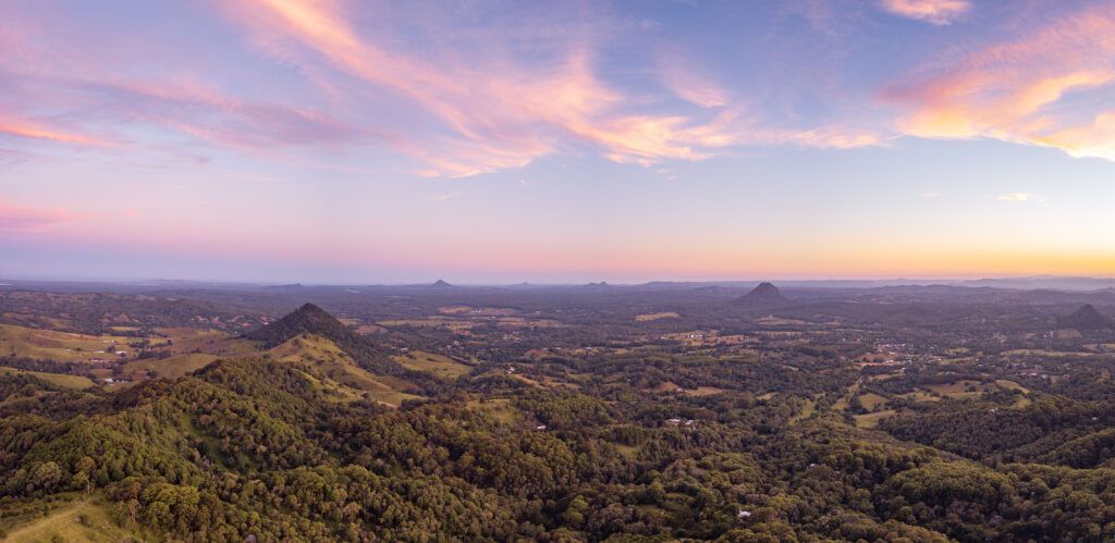 Aerial View of a Forest Landscape at Dusk, Under a Pastel Pink and Purple Sky — Ionspark Electrical in Biboohra, QLD