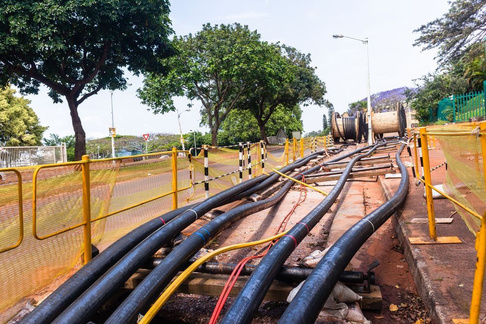 Cables Laid on Track With Safety Barriers Along Road, With Spools of Cable — Ionspark Electrical in Dimbulah, QLD