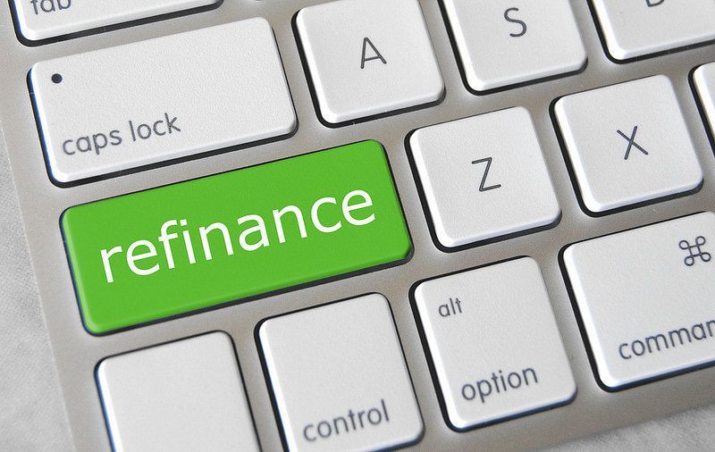 A keyboard with a green button that says refinance