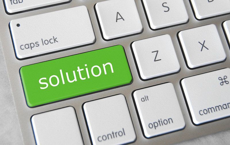 A keyboard with a green button that says solution