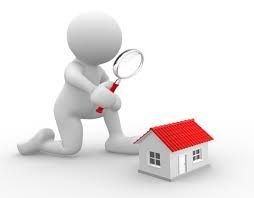 A 3d man is kneeling down and looking at a house through a magnifying glass.