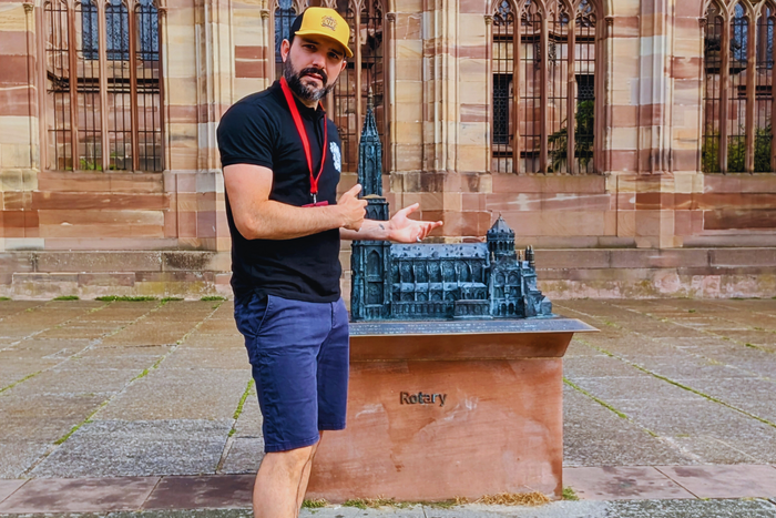 Yann Joffraud local tour guide next to the 3D bronze model of the Strasbourg Cathedral
