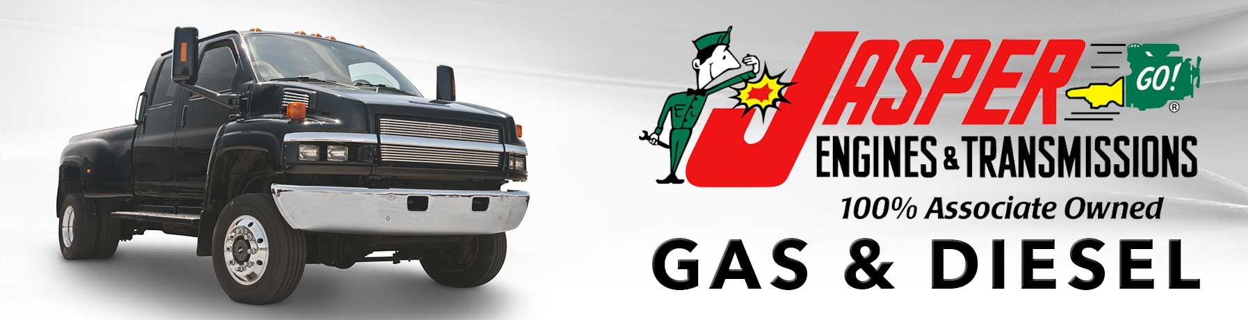 Black pickup truck beside Jasper Engines & Transmissions logo and