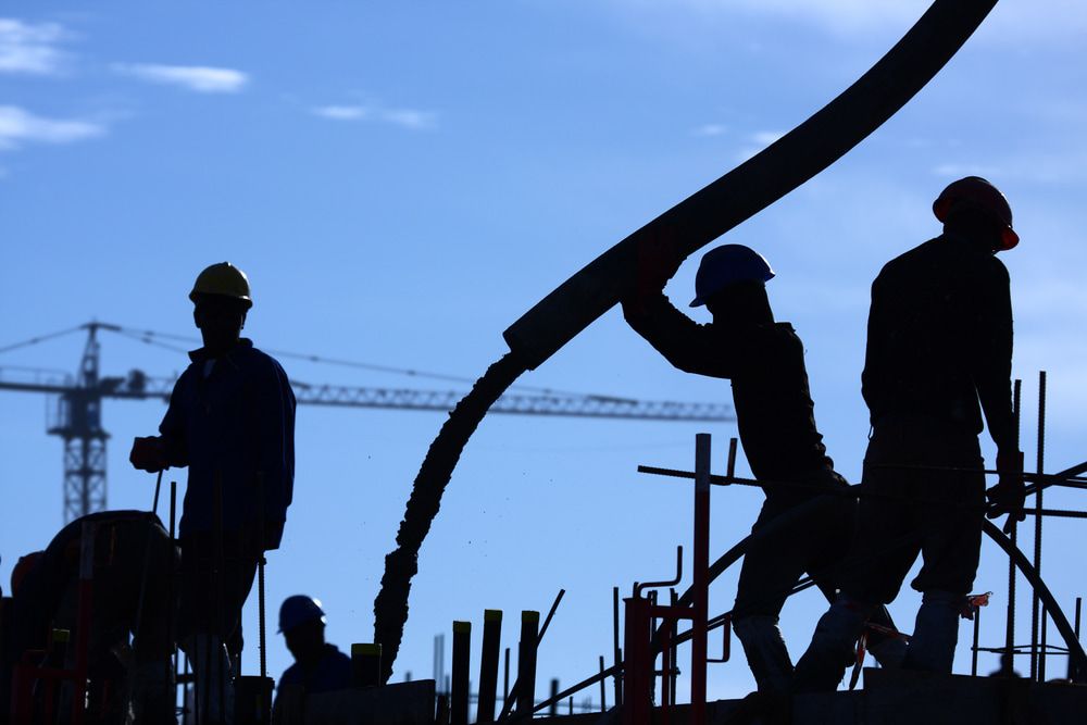 A Group Of Construction Workers Are Silhouetted Against A Blue Sky — Lonnie Henderson Concreting In Kurri Kurri, NSW