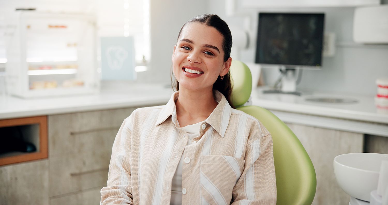 Patient seated in a dental clinic chair during a routine dental care appointment.