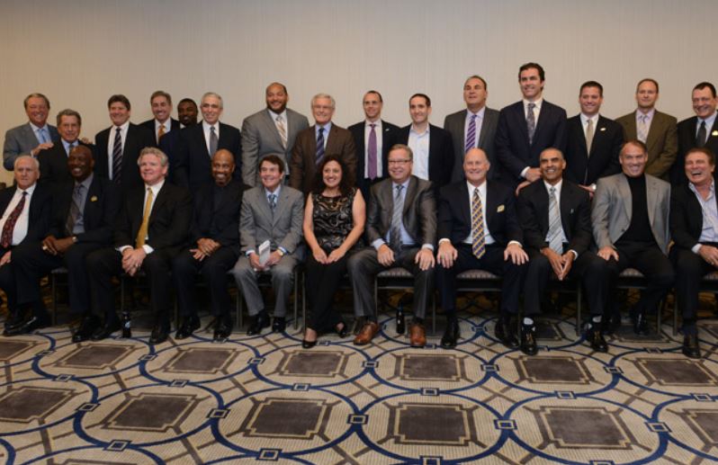 A large group of people are posing for a picture in a room.