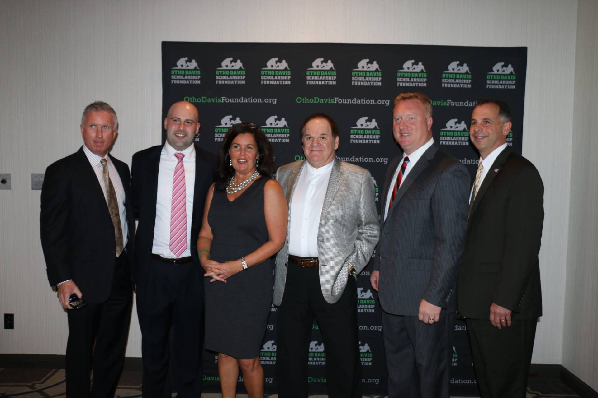 A group of men and women are posing for a picture