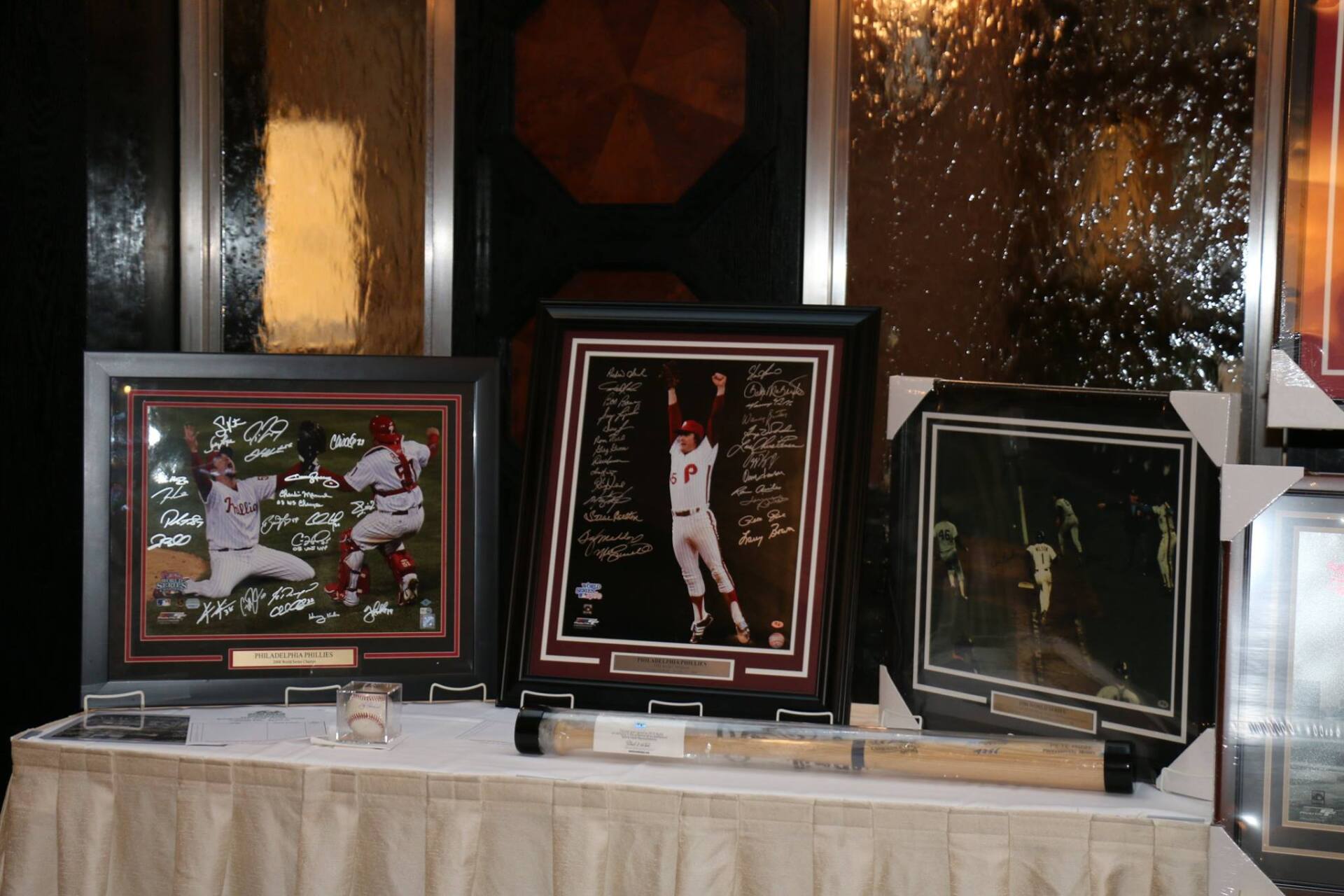 A table with a bunch of framed baseball pictures on it