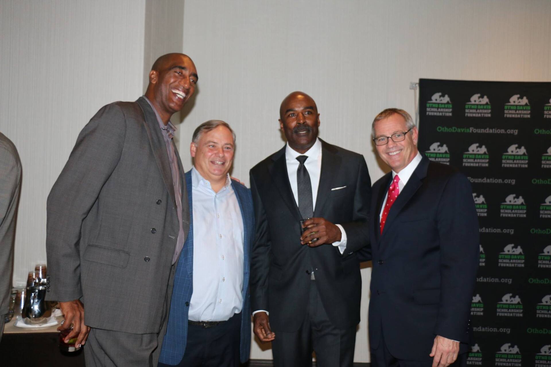 A group of men in suits are posing for a picture