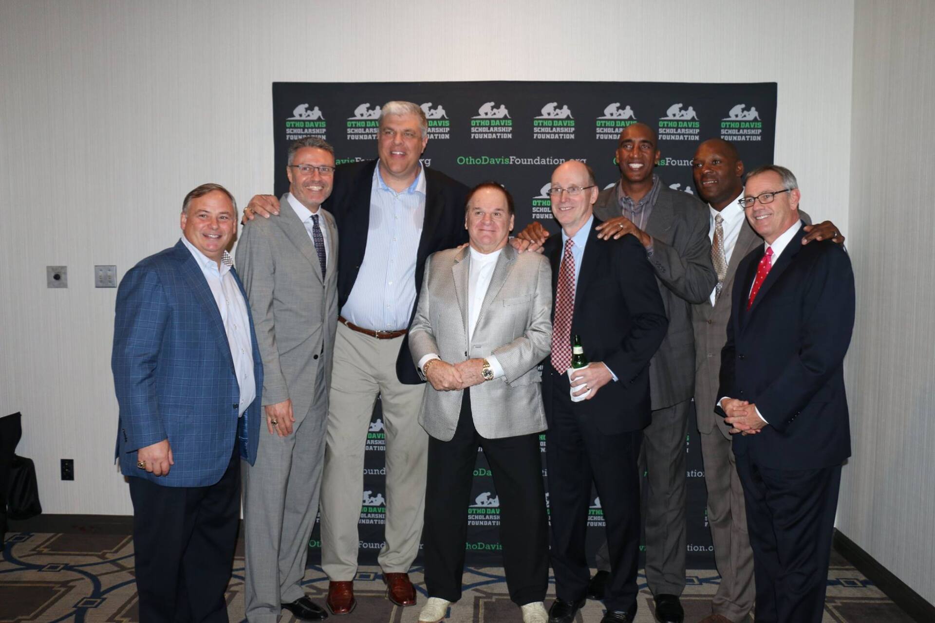 A group of men are posing for a picture in a room.