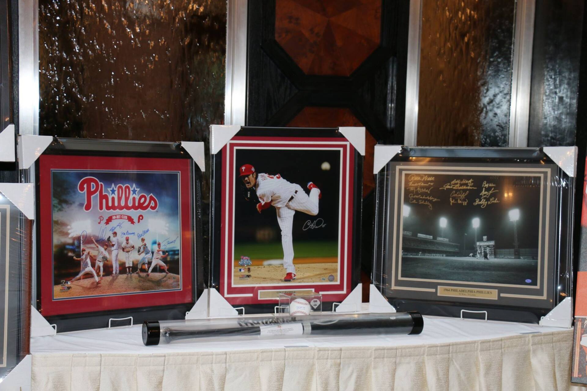Three framed pictures of phillies baseball players on a table