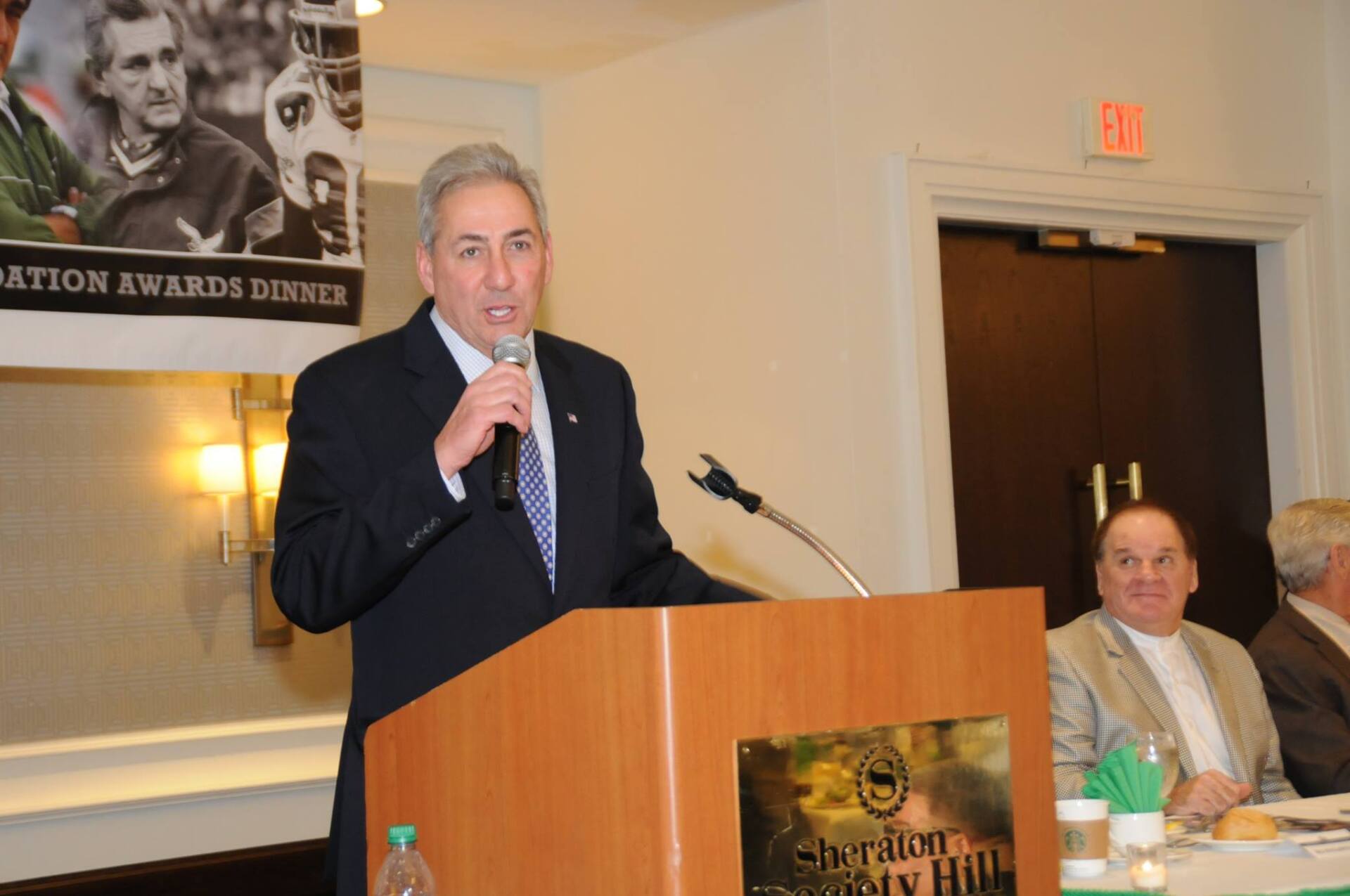 A man is standing at a podium giving a speech
