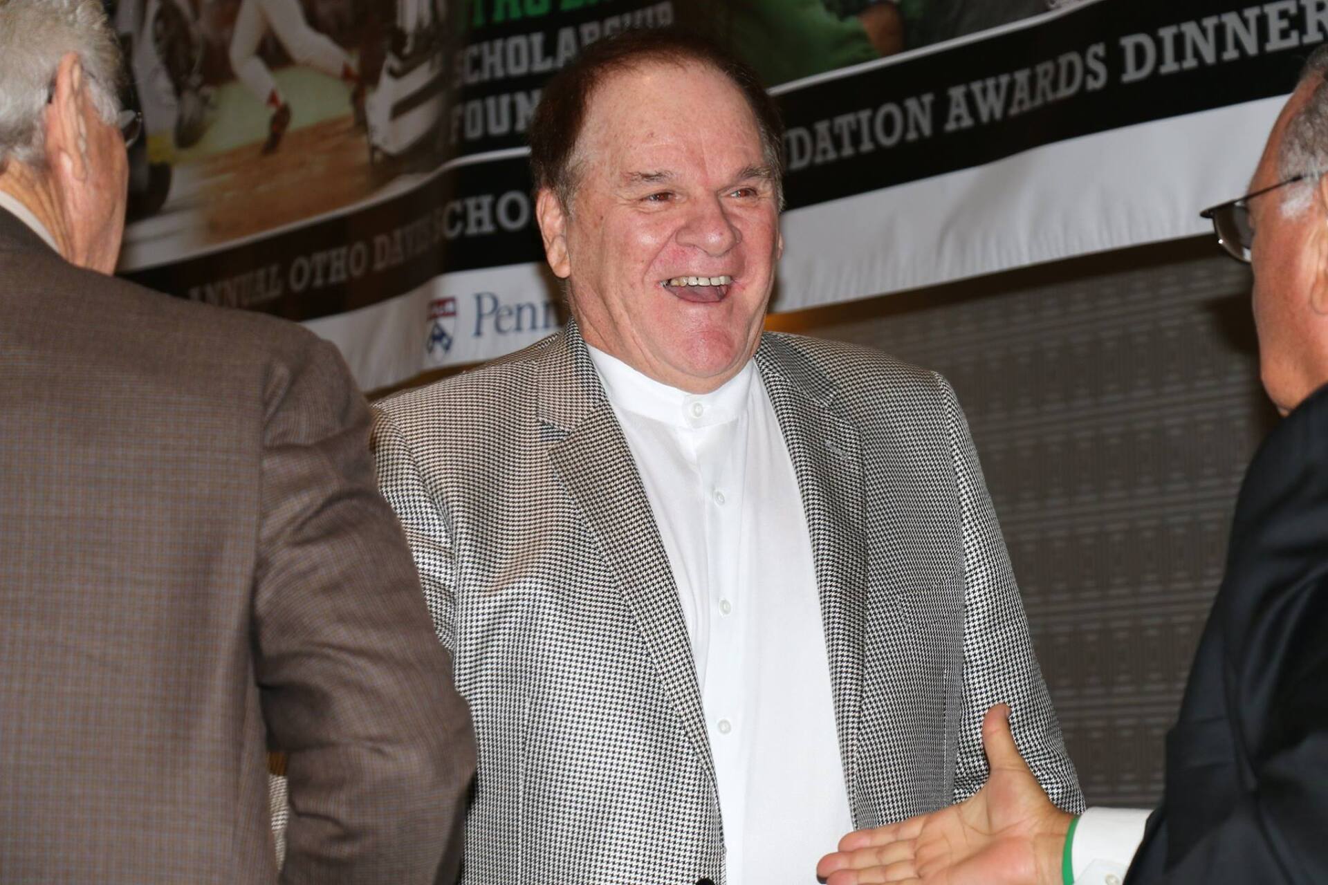 A man in a suit is shaking hands with two other men