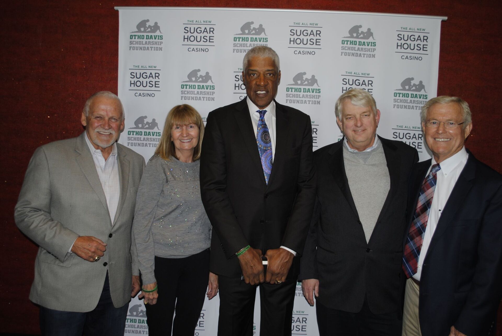 A group of people standing in front of a sign that says sugar house