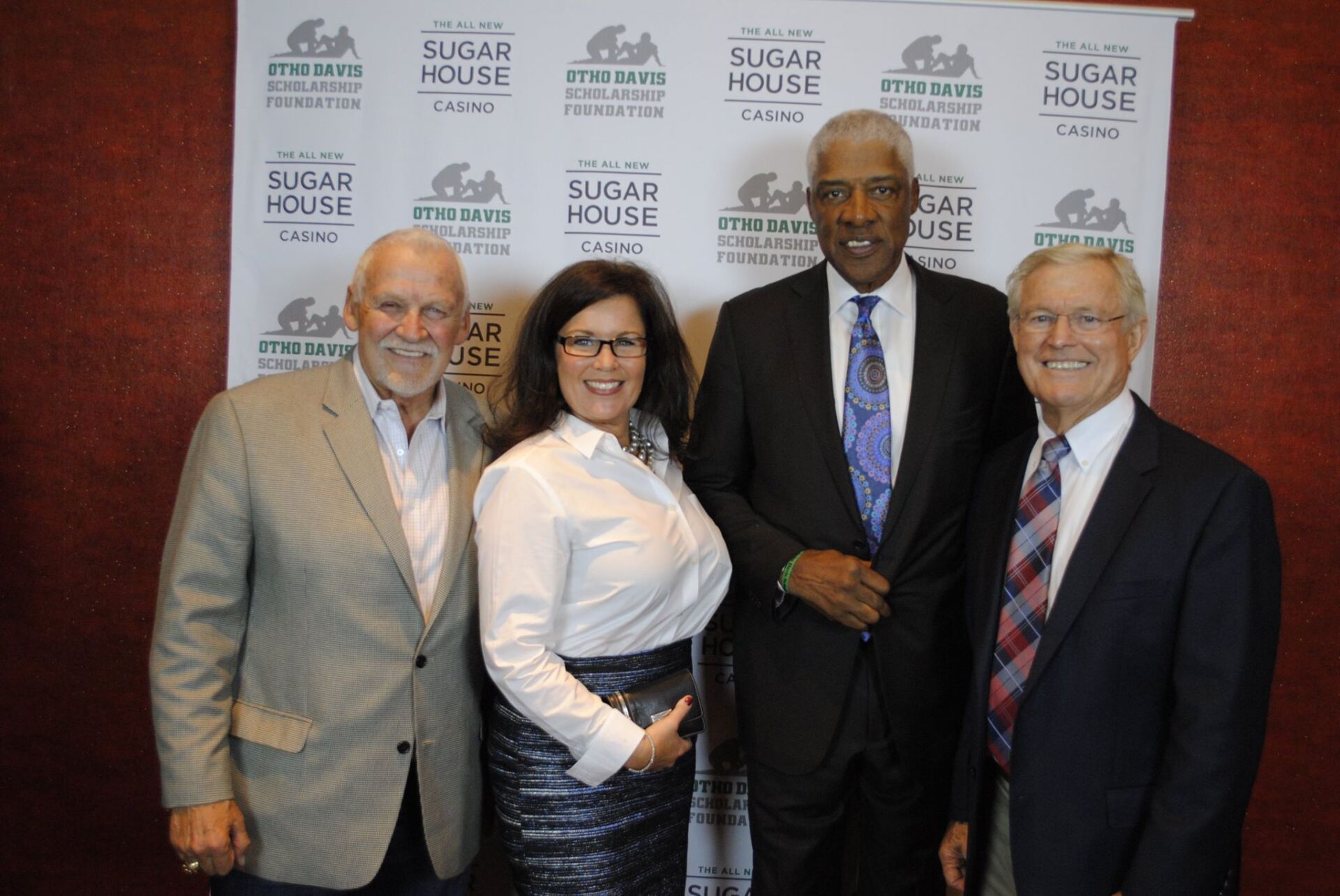 A group of people standing in front of a sign that says sugar house