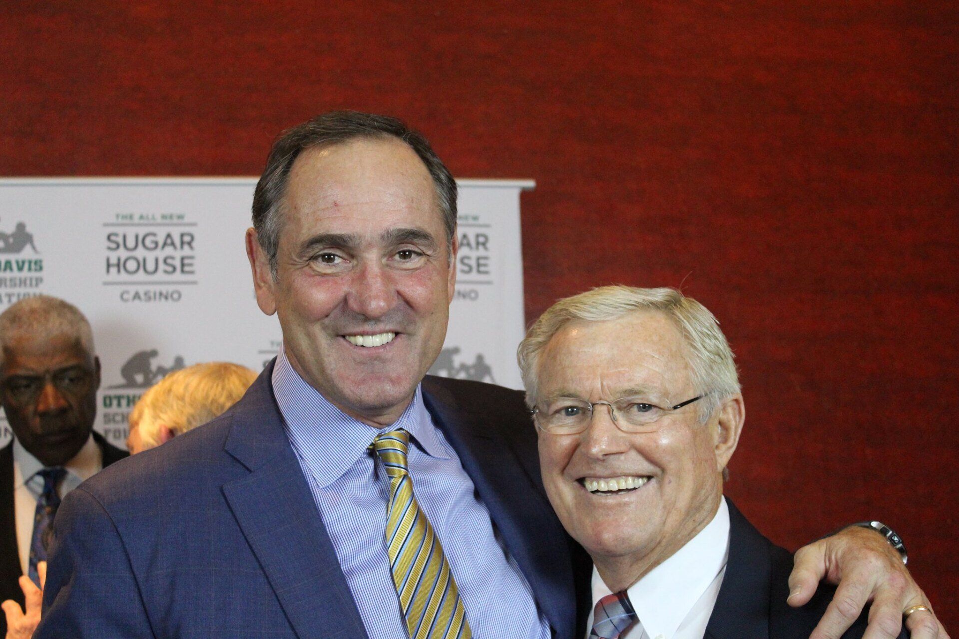 Two men in suits and ties are posing for a picture.