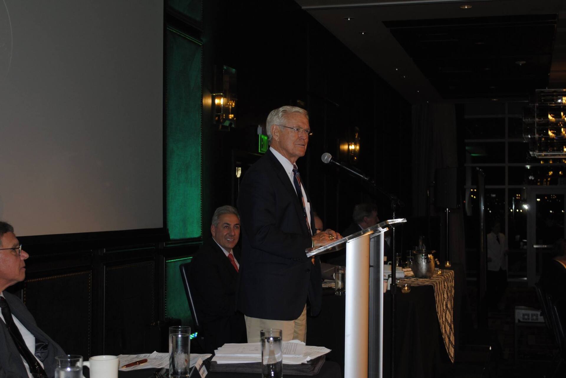 A man is standing at a podium giving a speech