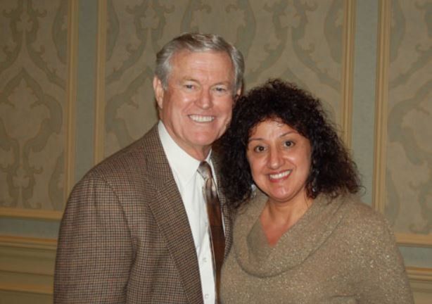 A man and a woman are posing for a picture together