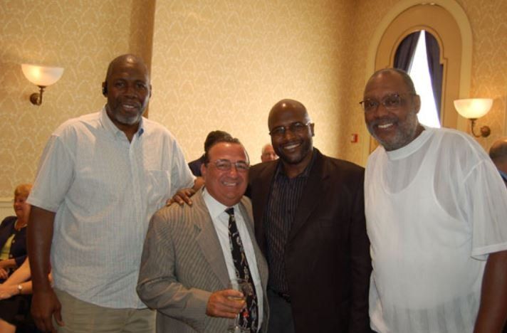 A group of men posing for a picture in a room