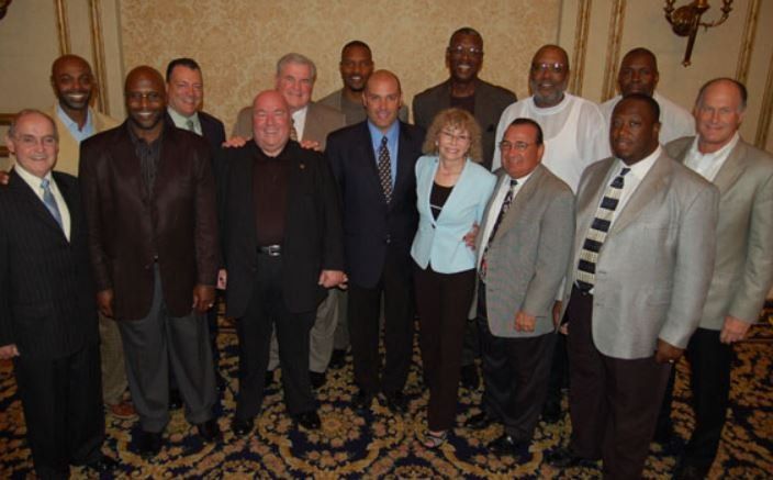A group of men and women are posing for a picture