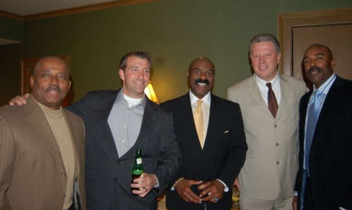 A group of men in suits and ties pose for a picture