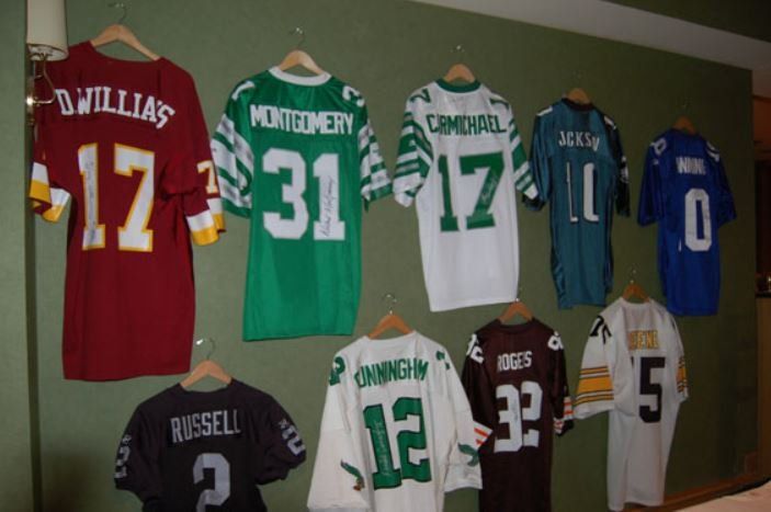 Jerseys hanging on a wall including one that says russell