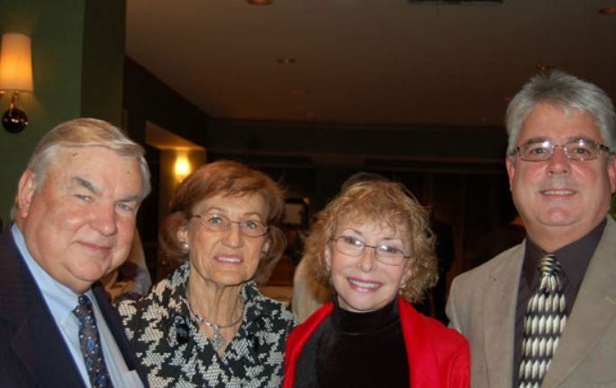 A group of people posing for a picture in a room