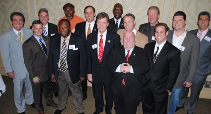 A group of men in suits and ties pose for a picture