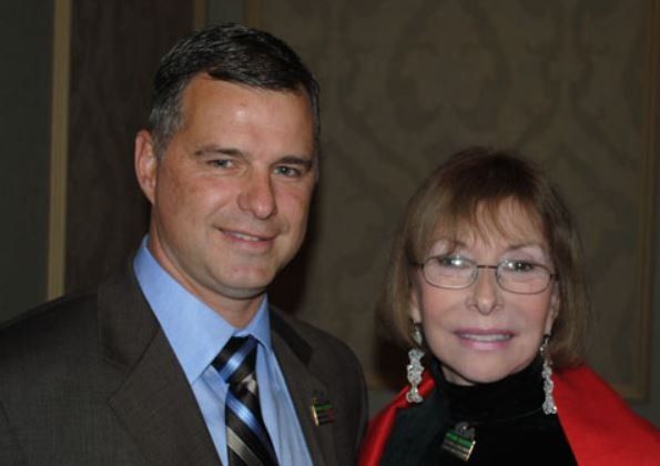 A man and a woman are posing for a picture together