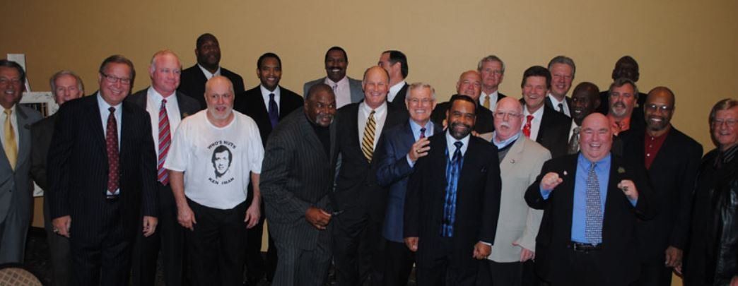 A group of men in suits and ties pose for a picture