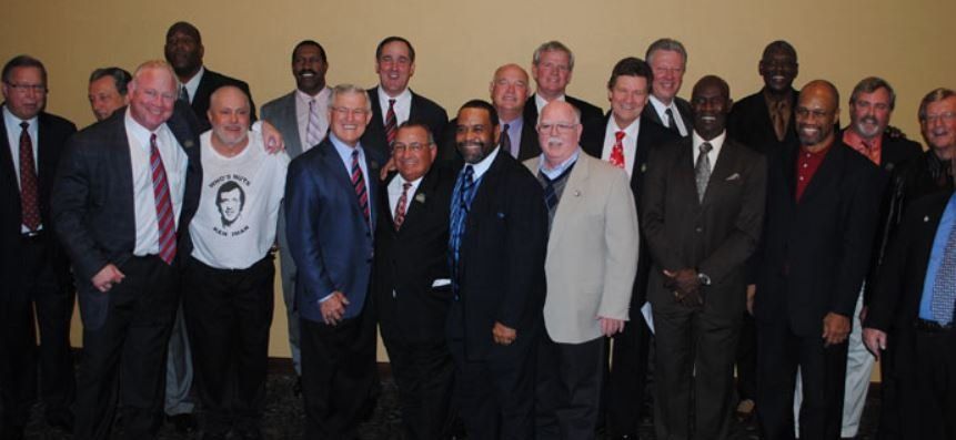 A group of men in suits and ties pose for a picture