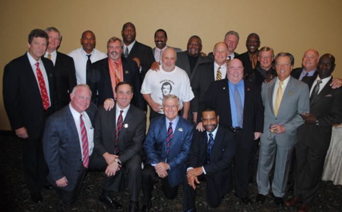 A group of men in suits and ties pose for a picture