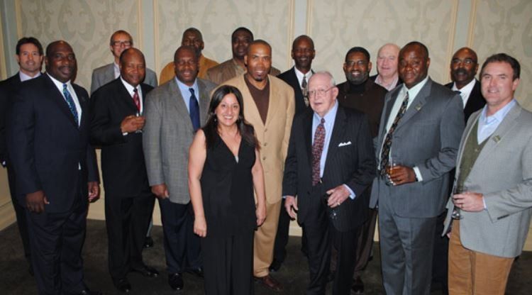 A group of men and women posing for a picture