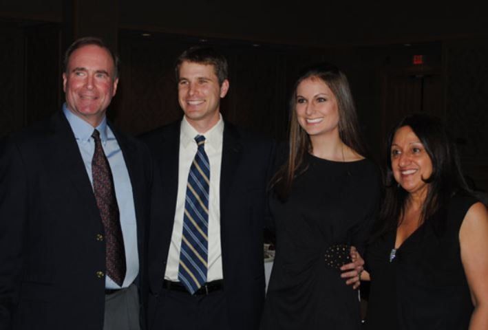A group of people posing for a picture in a dark room