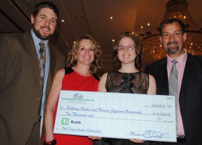 A group of people holding a check from td bank