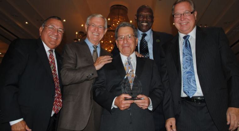 A group of men in suits and ties posing for a picture