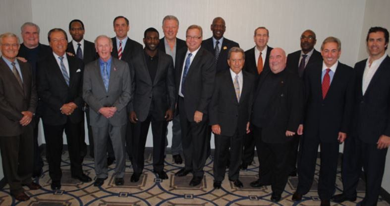 A group of men in suits and ties pose for a picture