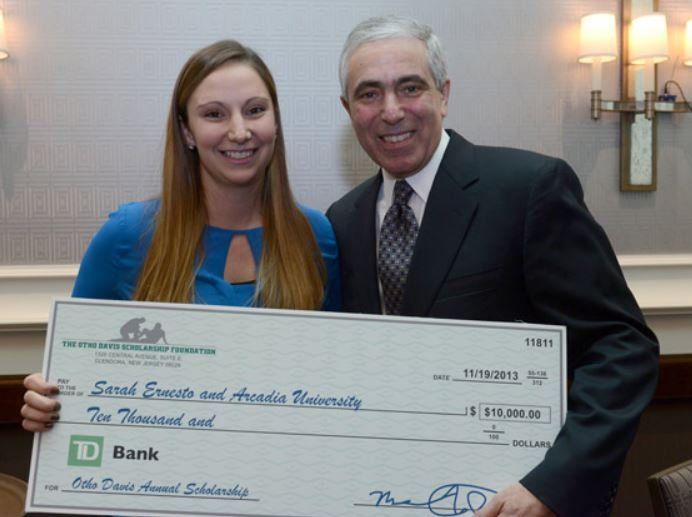 A man and a woman holding a td bank check