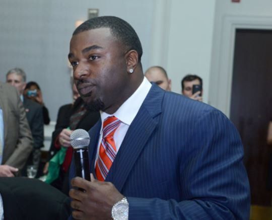 A man in a suit and tie is holding a microphone