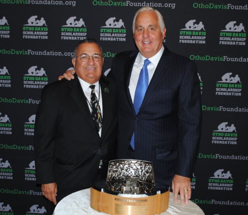 Two men are posing for a picture in front of a wall that says ohio davis foundation