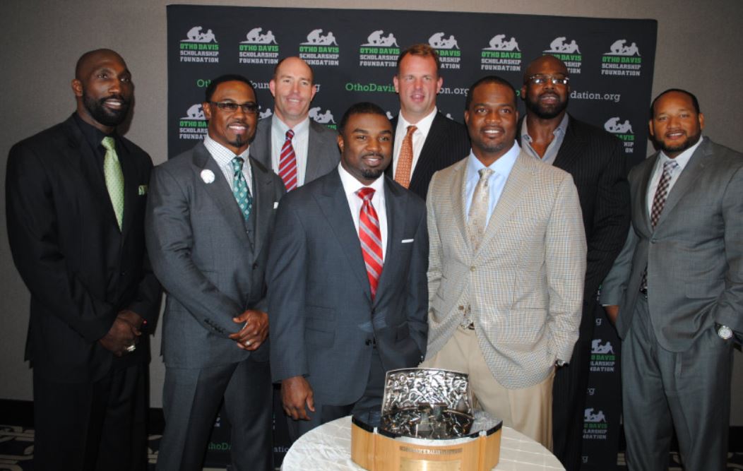 A group of men in suits and ties pose for a picture