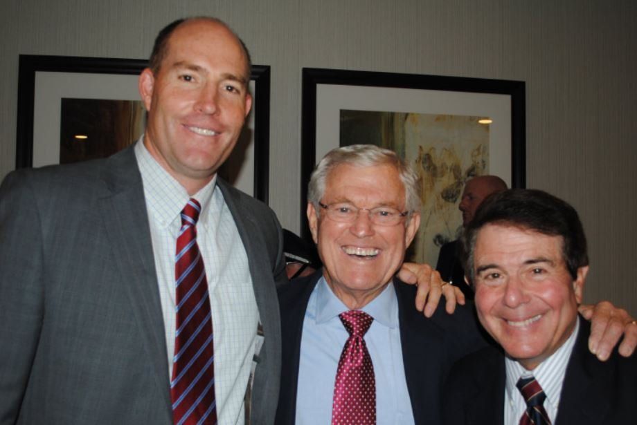 Three men in suits and ties posing for a picture