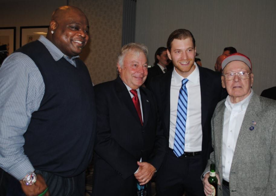 A group of men are posing for a picture together