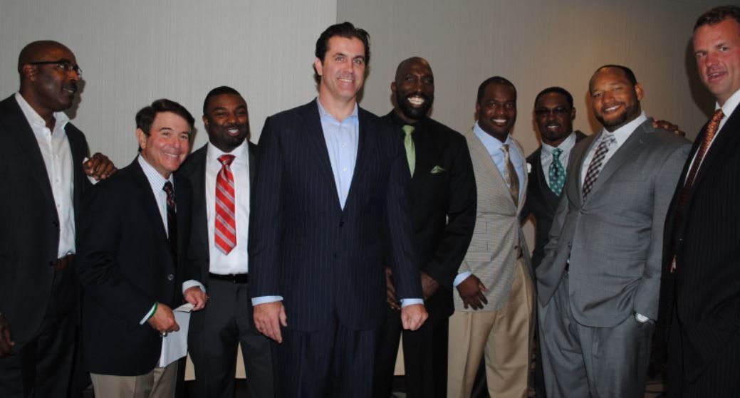 A group of men in suits and ties are posing for a picture
