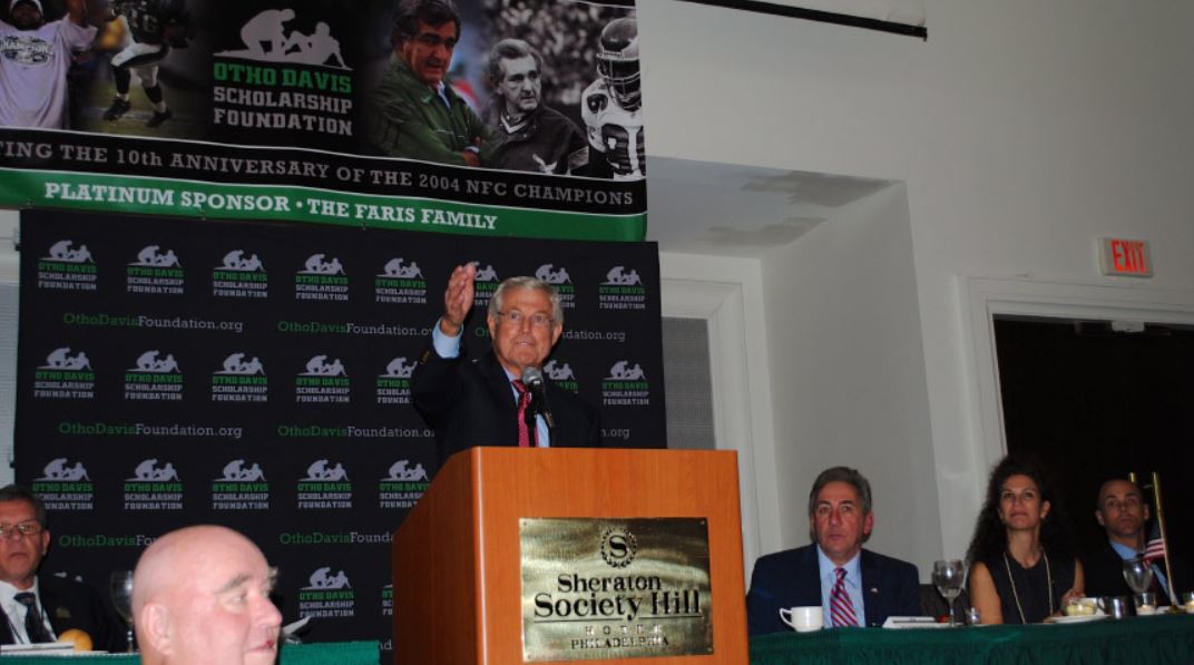 A man stands at a podium giving a speech