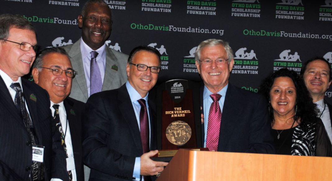 A group of people standing around a podium with the word ohio on the back