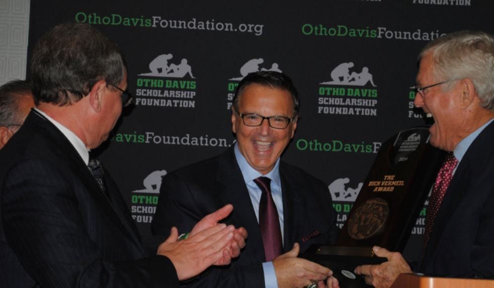 Three men are standing in front of a wall that says ohio davis scholarship foundation