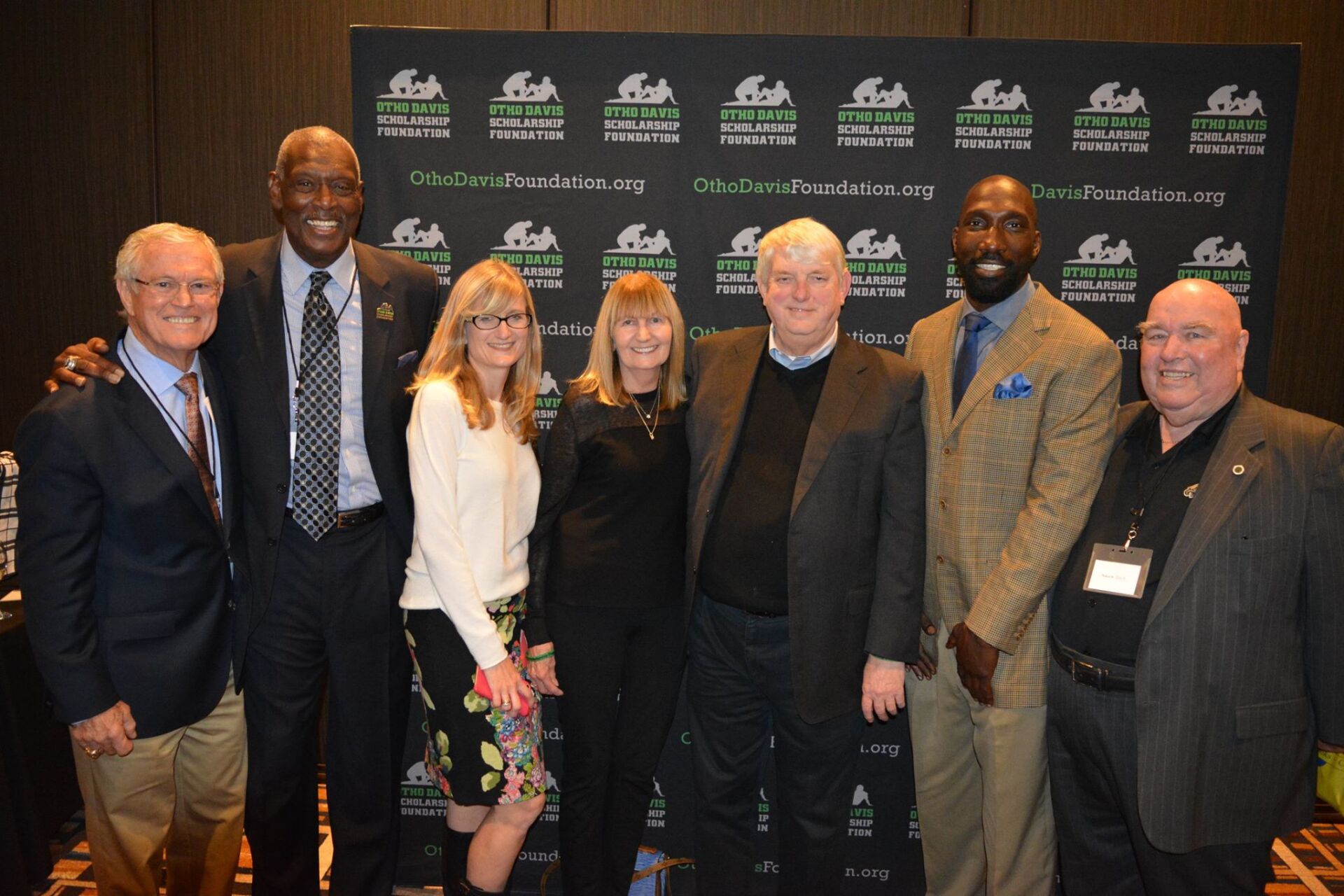 A group of men and women are posing for a picture.