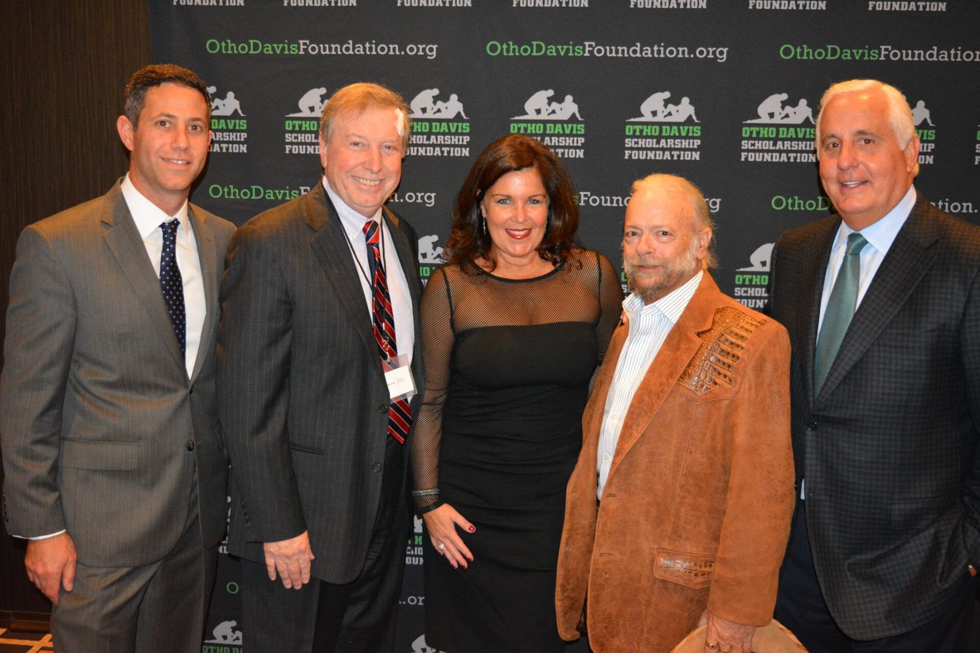 A group of men and women are posing for a picture